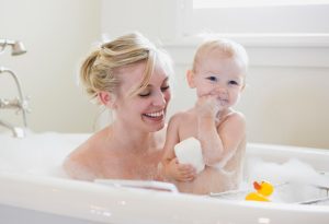 this is an image of a mother and a baby showering using PALMOSALT soap noodle.