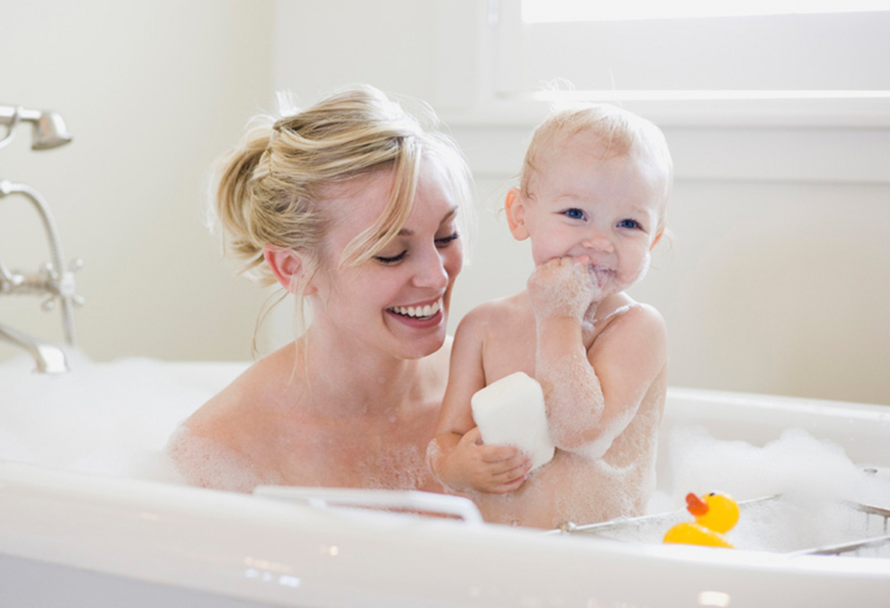 this is an image of a mother and a baby showering using PALMOSALT soap noodle.